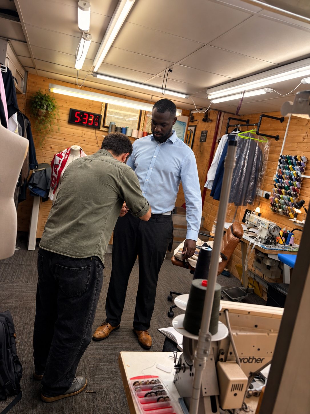 A Fix2Fit tailor fitting a guest's trousers during a Tailoring Night in one of our Manchester tailoring rooms